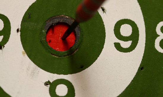 A dart in a red bullseye (10) surrounded by green and white rings. Photo credit Anne Nygard.